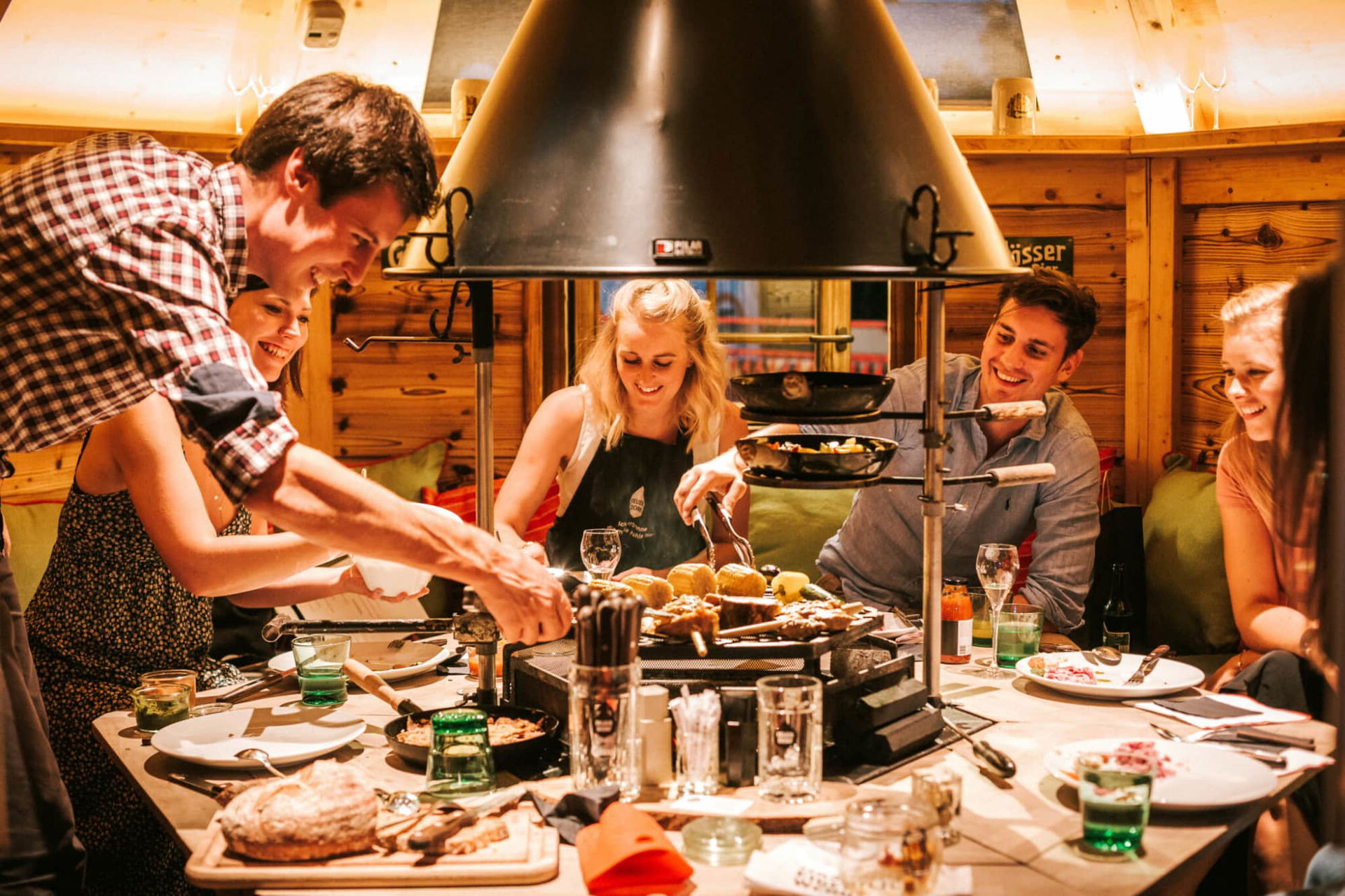 eine mit Menschen voll besetzte Grillhütte beim Feuerdorf in Wien