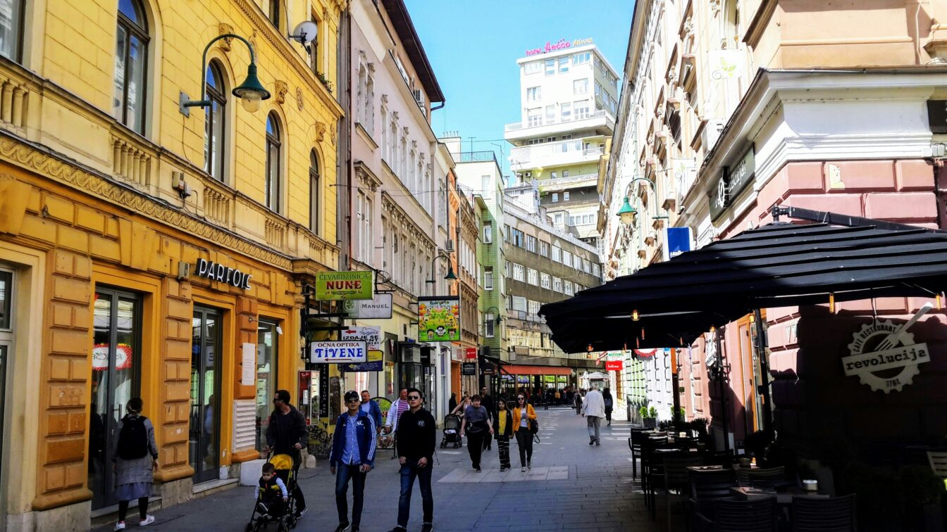 https://unsplash.com/de/fotos/eine-gruppe-von-menschen-die-eine-strasse-neben-hohen-gebauden-entlang-gehen-ej0JdHQs0OE Sarajevo Lokale