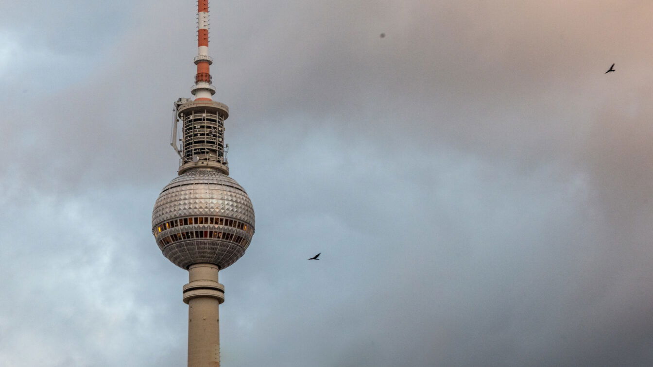 (c) Sonja Koller | 1000things Berliner Fernsehturm bei bewölktem Himmel – ikonisches Wahrzeichen am Alexanderplatz in Berlin, Deutschland