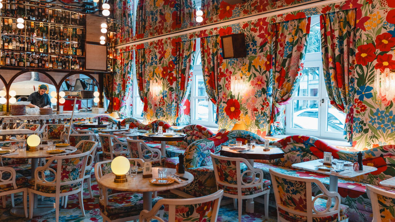 (c) Lilli Wermuth | 1000things Ein bunter Innenraum eines Restaurants in München mit Blumentapete und kitschigen Details.