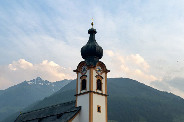 Kirchturm vor Bergpanorama