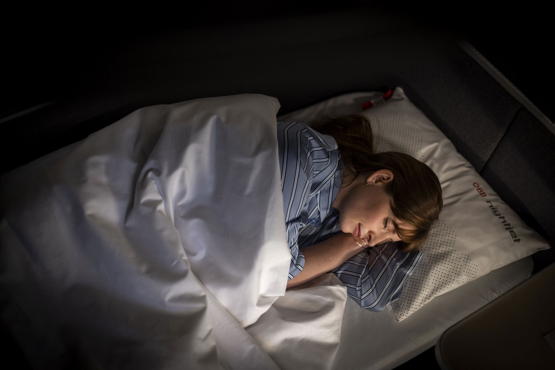 Frau schläft im Nachtzug