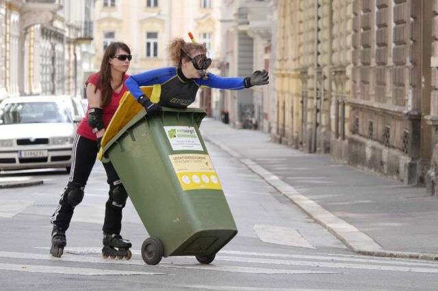 Mensch schiebt anderen Menschen in Mülltonne - Wiener Fotomarathon