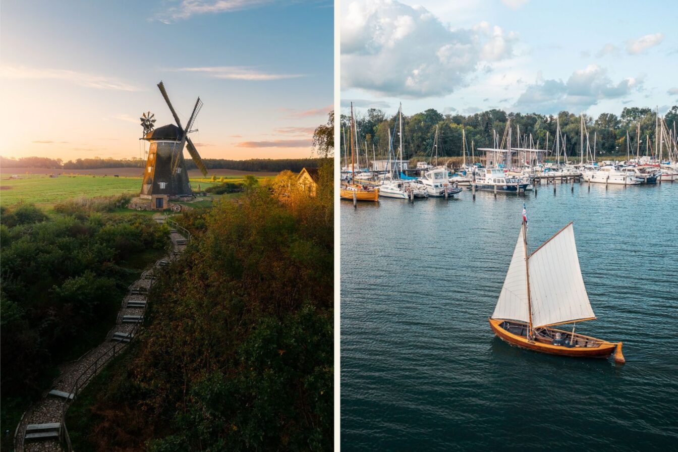 Links eine historische Windmühle auf einer grünen Wiese im warmen Abendlicht, rechts ein kleiner Yachthafen mit Segelbooten und einem traditionellen Holzsegelboot auf dem Wasser vor blauem Himmel.