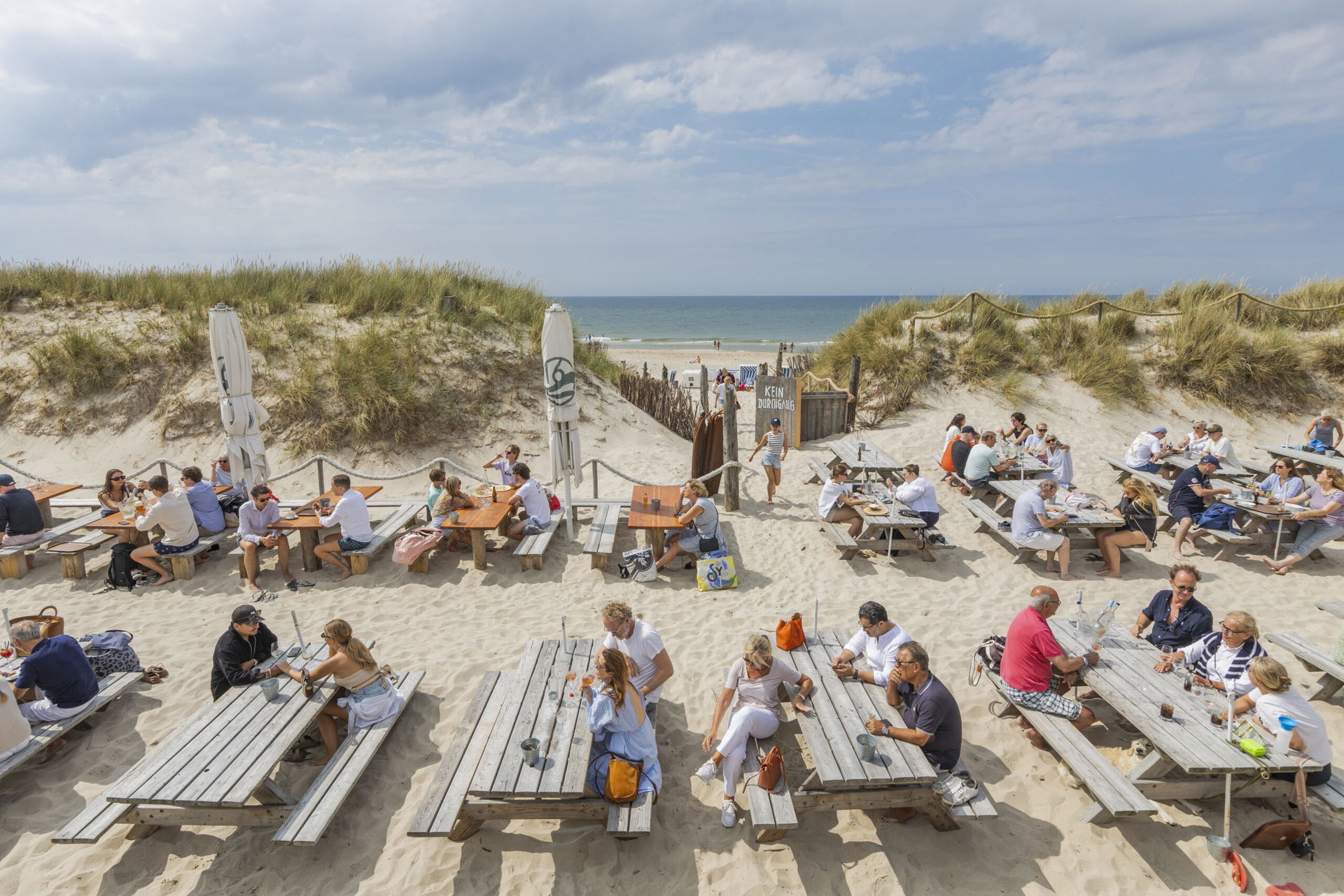 Menschen in den Dünen am Meer beim Essen