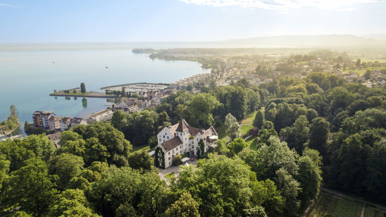Luftaufnahme von Schloss Wartegg am Bodensee mit Schlosspark, Hafen Rorschach und Bergpanorama